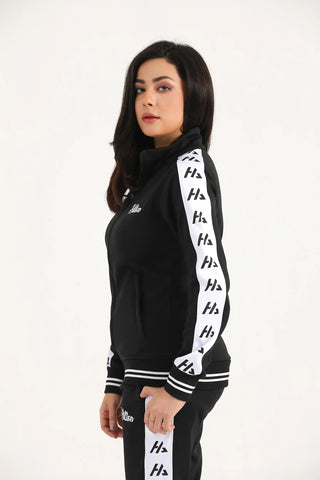 Woman modelling a black athletic zip-up jacket with contrast sleeve panels, side view