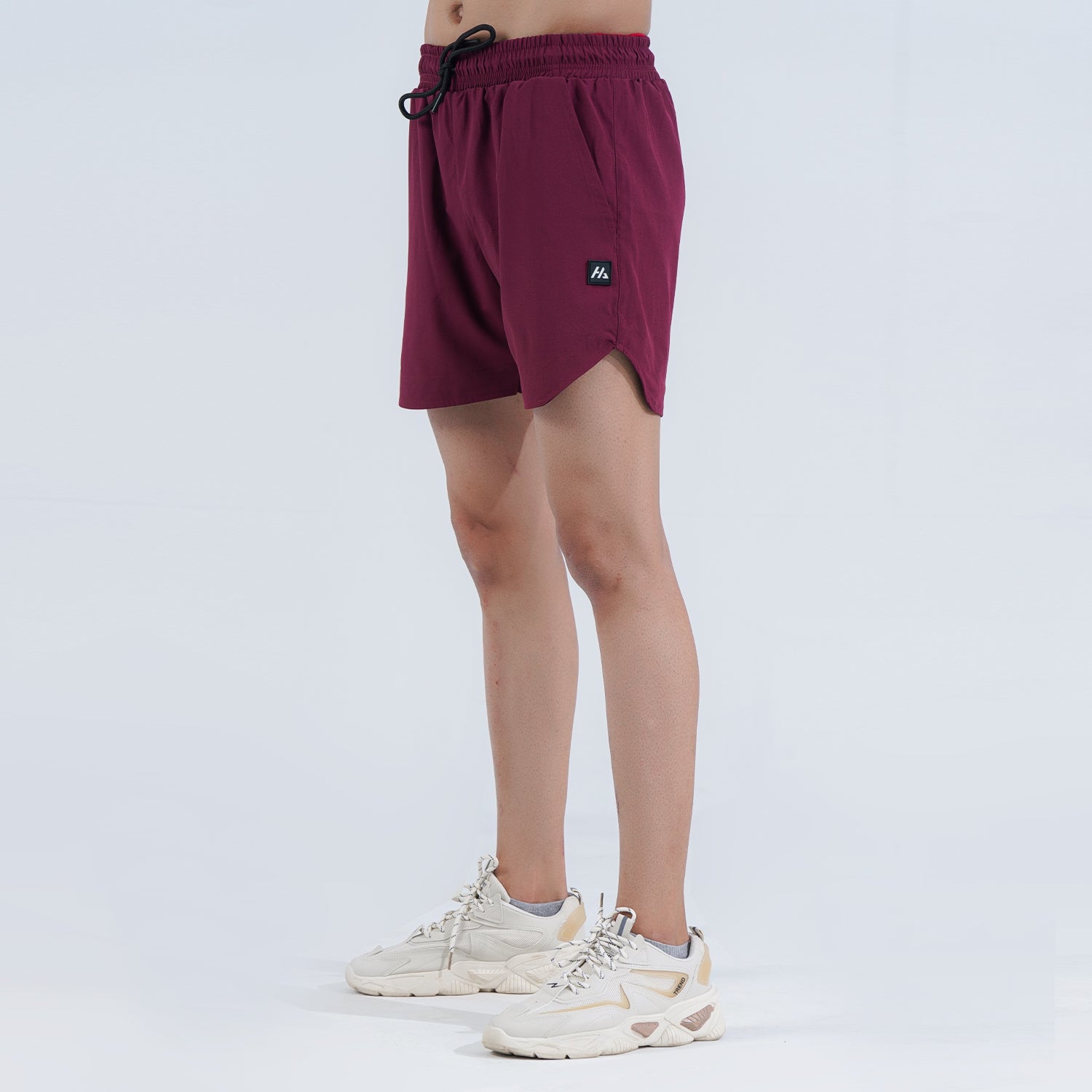 Hilton Aesthetics Ultimate Performance Shorts in burgundy with lightweight athletic fit side view