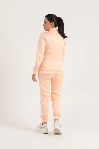 Back view of women’s peach zip-up jacket with matching joggers