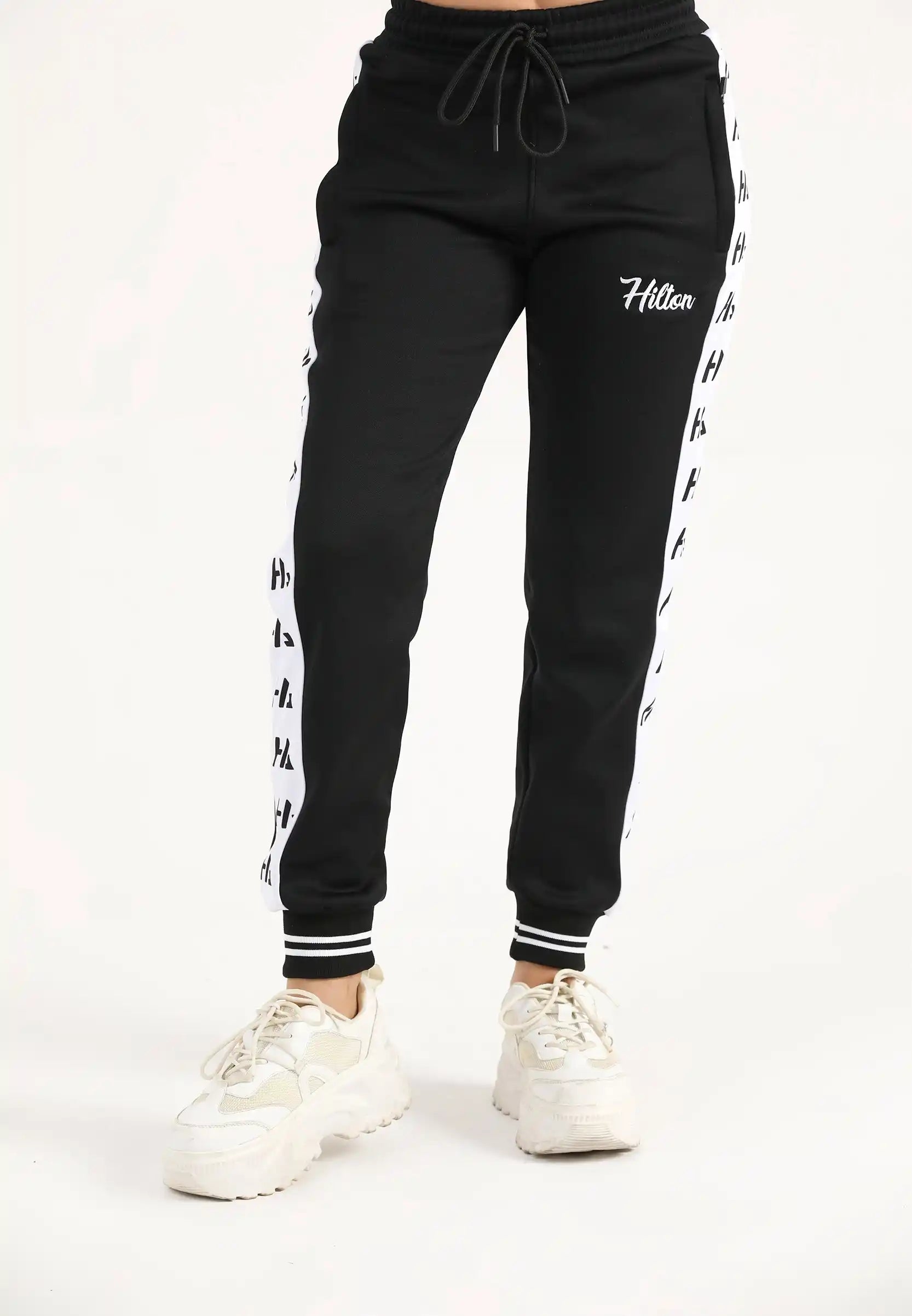 Women's black classic zipper joggers with tapered fit and Hilton Aesthetics embroidered logo