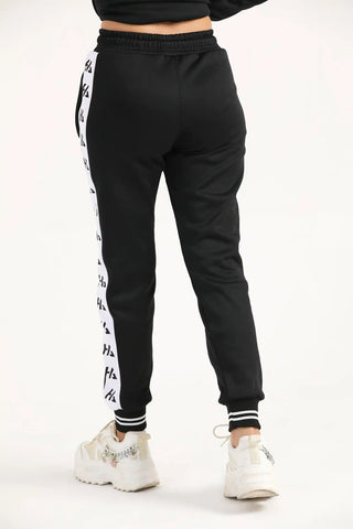 Back view of women's black classic zipper joggers with elastic waistband and tapered leg