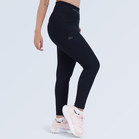 Side view of model walking in black high-waist pocket leggings, Hilton Aesthetics