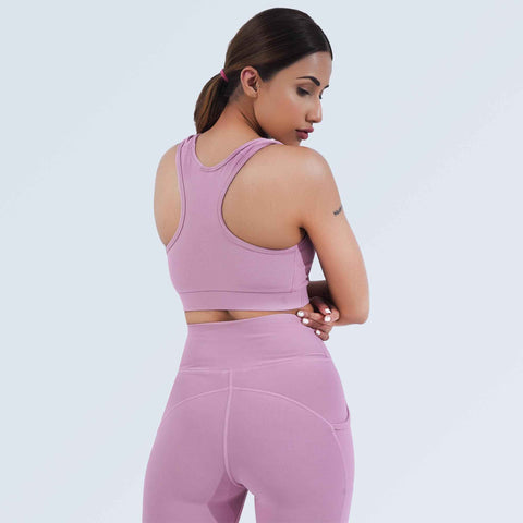Woman modelling Hilton Aesthetics dusty plum pocket leggings, back view