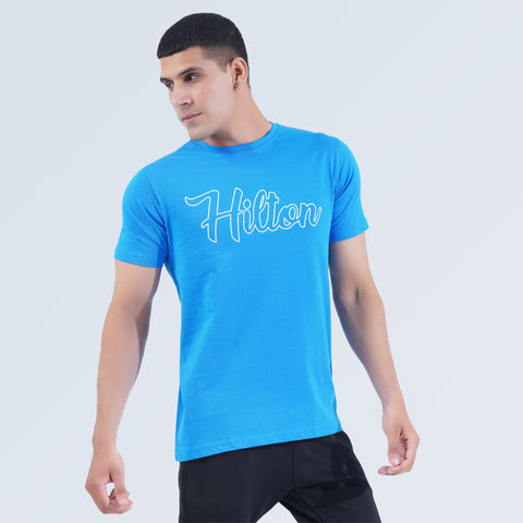 Side view of Sky Blue Crest Tee, lightweight 100% cotton casual T-shirt by Hilton Aesthetics