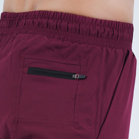 Close-up of zip pocket on Hilton Aesthetics Ultimate Performance Shorts in burgundy