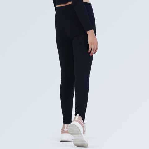 Woman wearing black high-waist ribbed workout leggings, side view