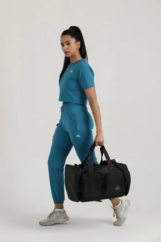 Model carrying Hilton Aesthetics Everyday Holdall Gym Bag in Black for gym workouts, travel, and everyday use.