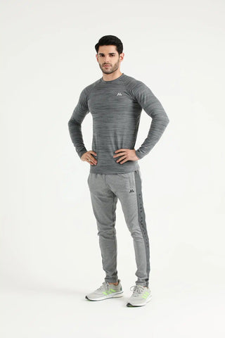 Man modelling grey Hilton Aesthetics Elite Joggers with a matching training top