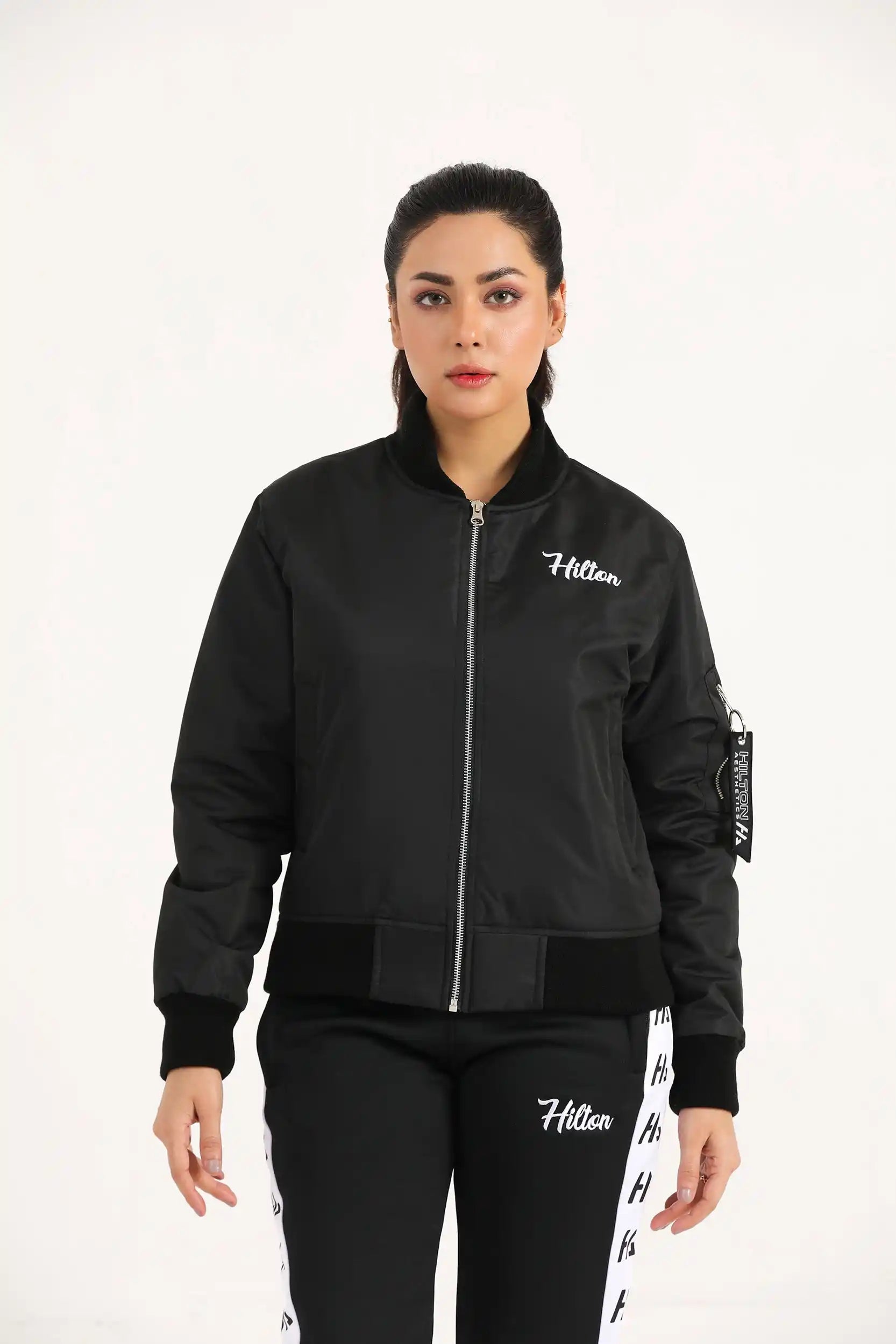Hilton Aesthetics Women's Bomber Jacket front view in black with zip closure and relaxed fit