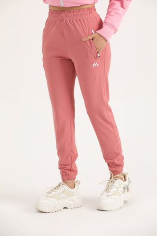 Women’s light coral Trace Joggers showing the concealed side zip pocket