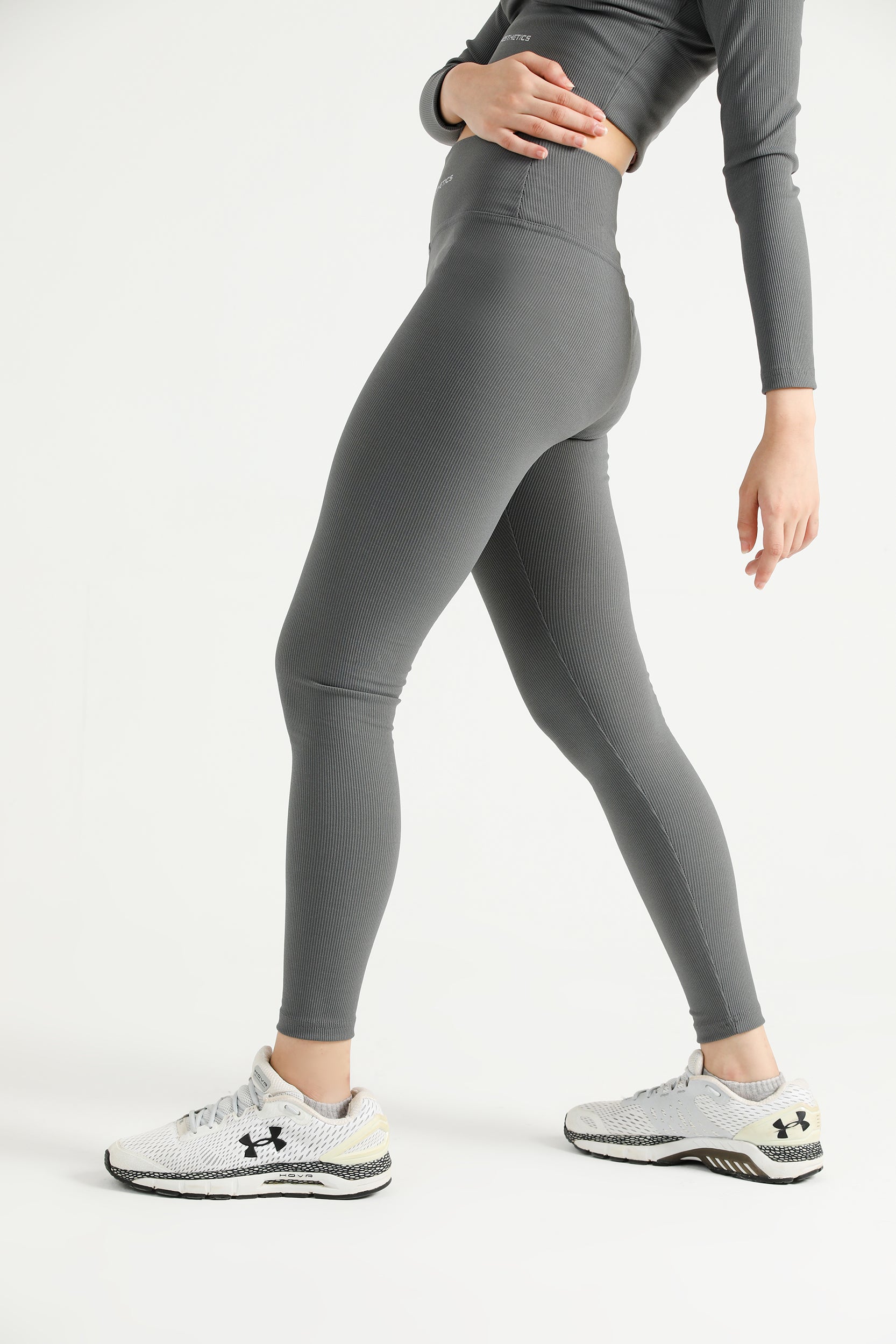 Woman wearing grey Hilton Aesthetics high-waist ribbed leggings