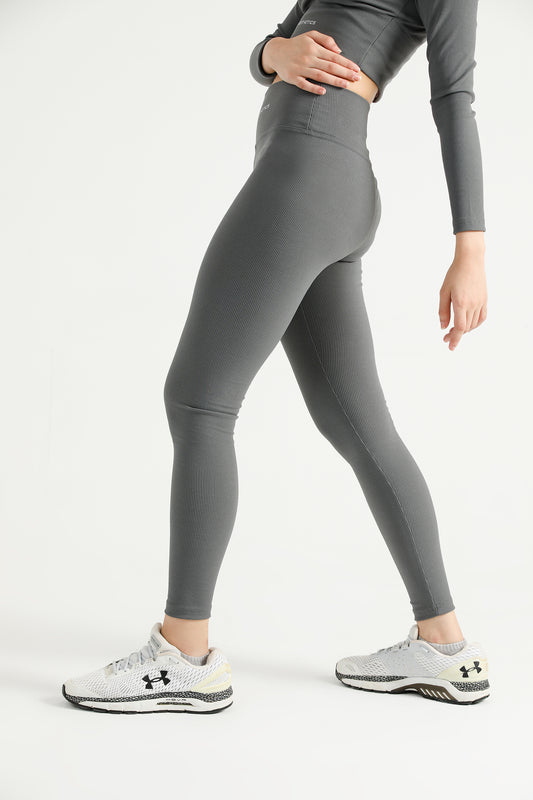 Woman wearing grey Hilton Aesthetics high-waist ribbed leggings