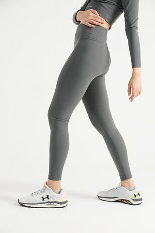 Woman wearing grey Hilton Aesthetics high-waist ribbed leggings