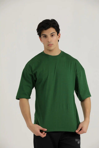 Model wearing Hilton Aesthetics Lifting Oversized T-Shirt in green with oversized fit and short sleeves