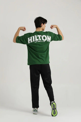 Full body view of Hilton Aesthetics Lifting Oversized T-Shirt in green for gym and casual wear