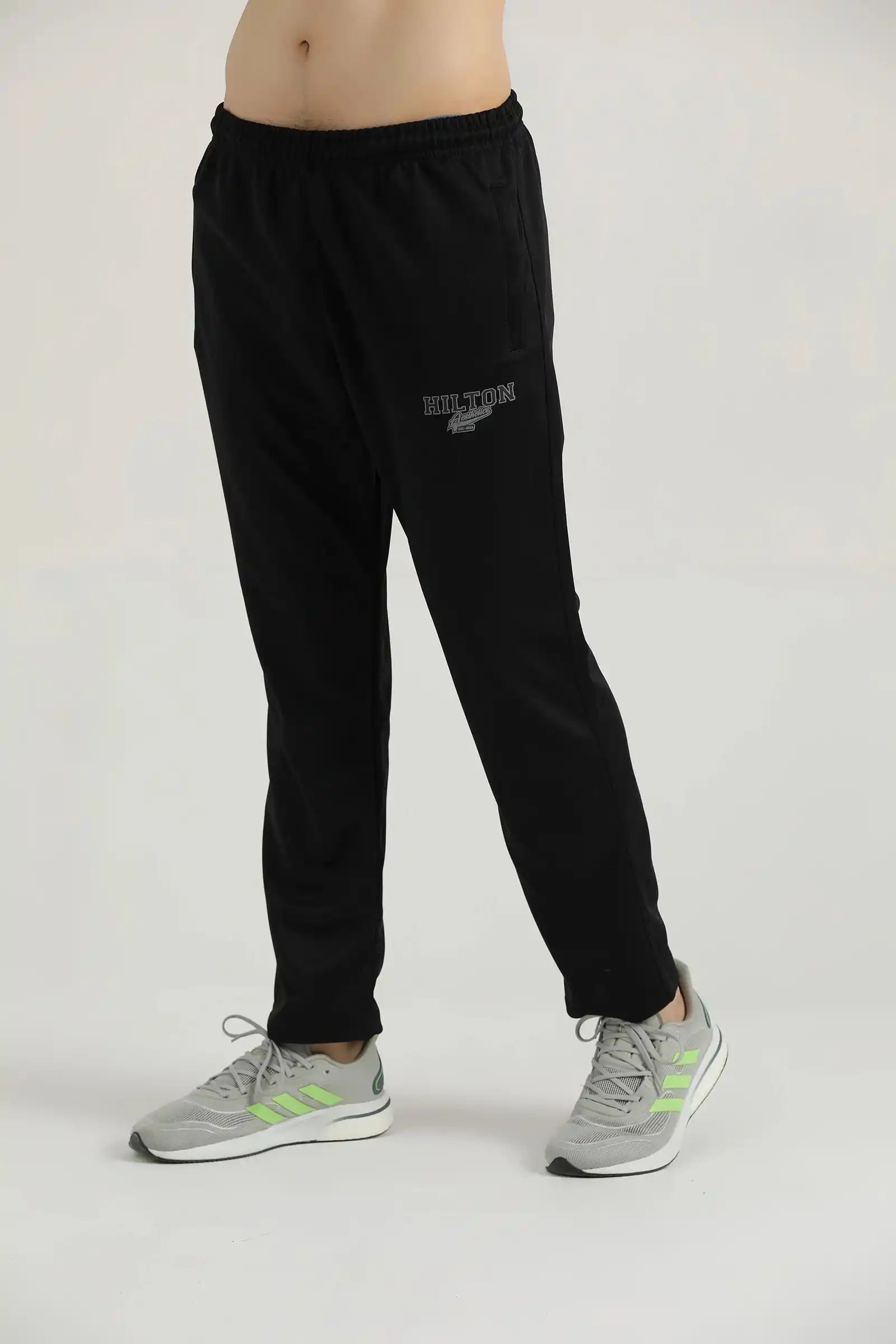 Side view of a model wearing black Lifting Relaxed Joggers by Hilton Aesthetics.