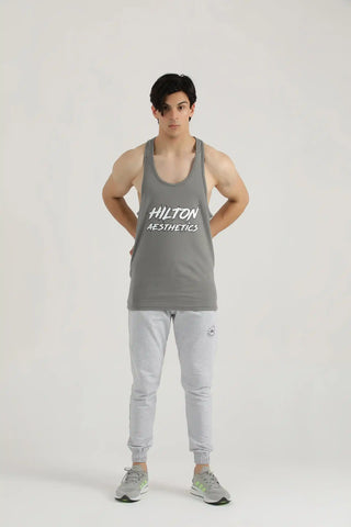 Man modelling a grey Power Stringer Tank Top with light grey joggers