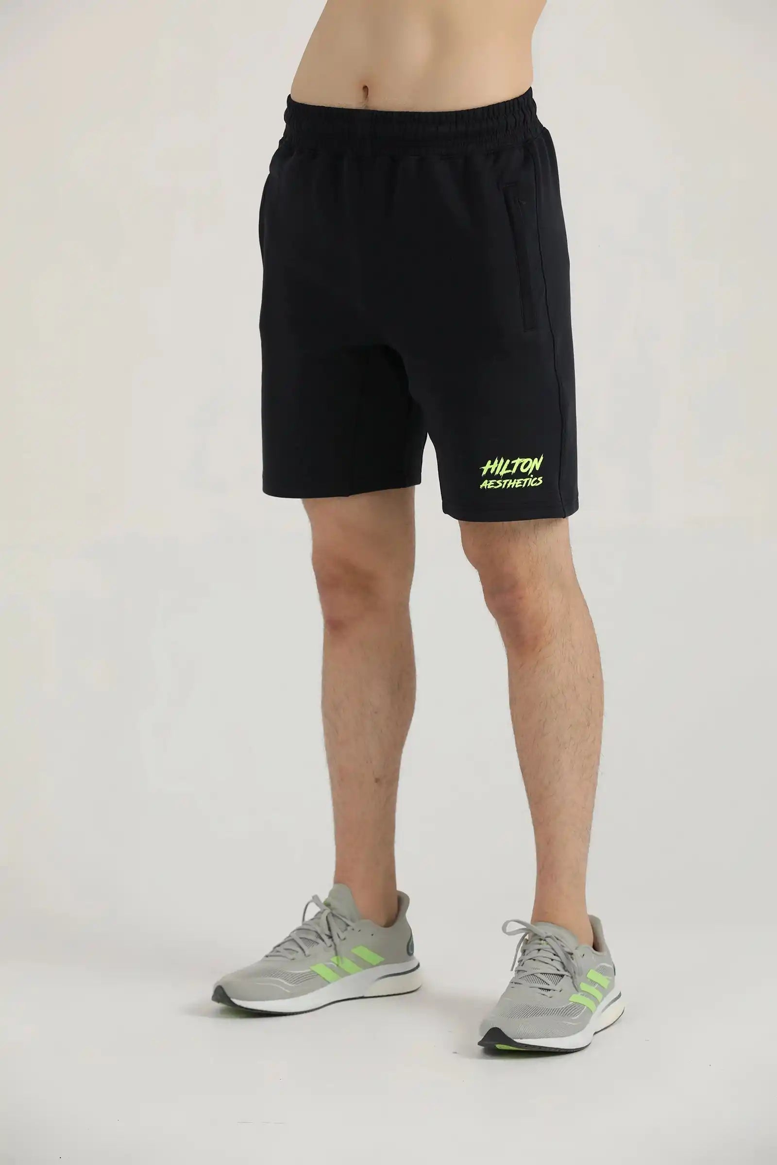 Front view of a male model wearing black athletic Studio Shorts by Hilton Aesthetics