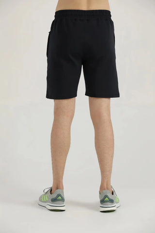 Back view of a model wearing black Hilton Aesthetics Studio Shorts