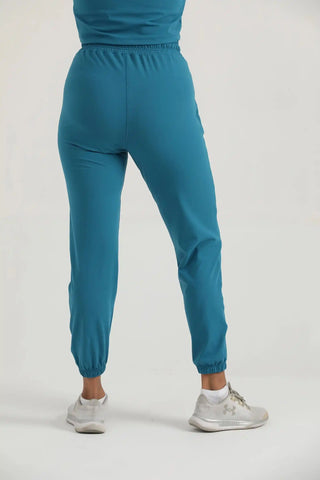 Back view of Hilton Aesthetics Trace Joggers in teal with tapered legs for gym training and everyday wear.