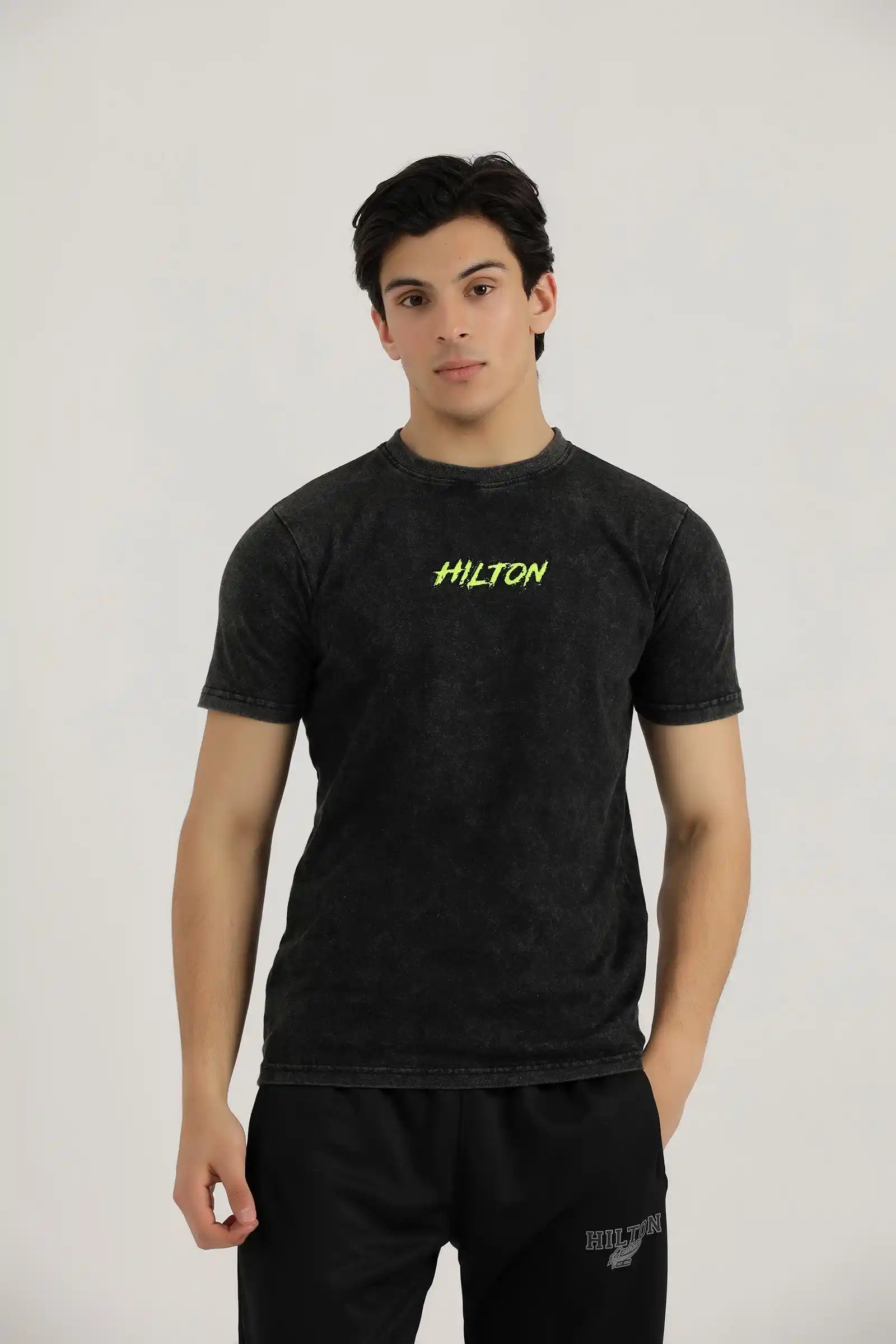 Hilton Aesthetics Vintage Washed T-Shirt front view in black with premium washed fabric and embroidered chest logo