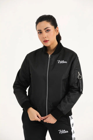 Hilton Aesthetics Women's Bomber Jacket angled front view in black with premium fabric and ribbed cuffs