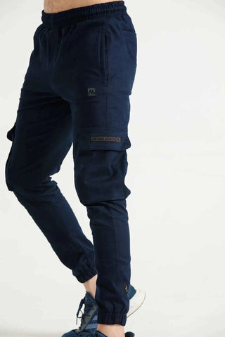 Man wearing navy Hilton Aesthetics cargo joggers with utility pockets, side view