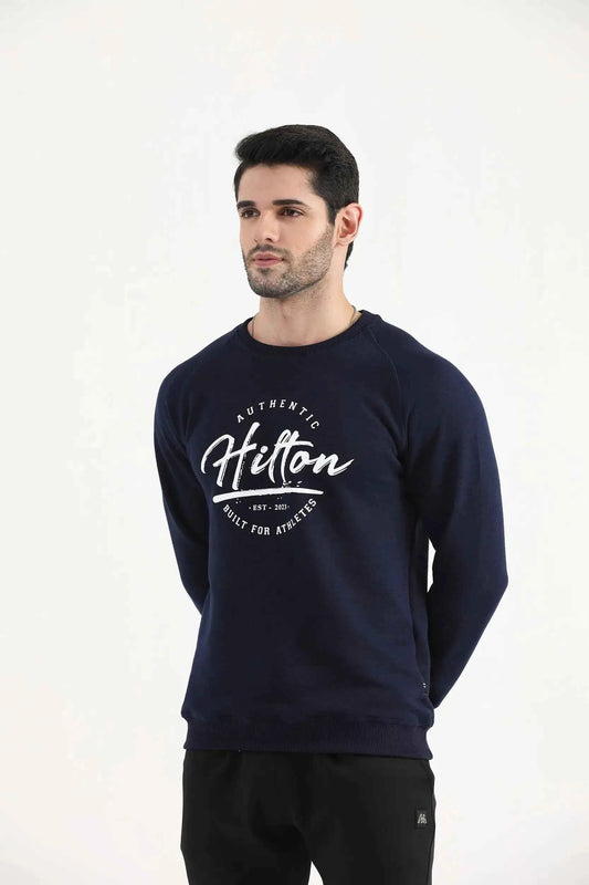 Man wearing a navy Hilton Aesthetics Classic Crew sweatshirt, front view