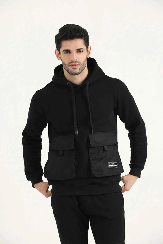 Man wearing black Hilton Aesthetics Crest Cargo Hoodie, front view