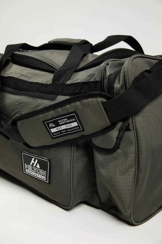 Hilton Aesthetics Essential Duffel Bag in grey with zip compartments, top angled view