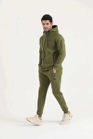 Man modelling dark olive green Flexx Joggers by Hilton Aesthetics, full-length view