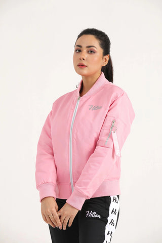 Woman wearing light pink Hilton Aesthetics Quilted Bomber Jacket, front view