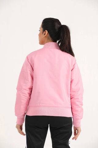 Back view of woman wearing light pink Hilton Aesthetics Quilted Bomber Jacket
