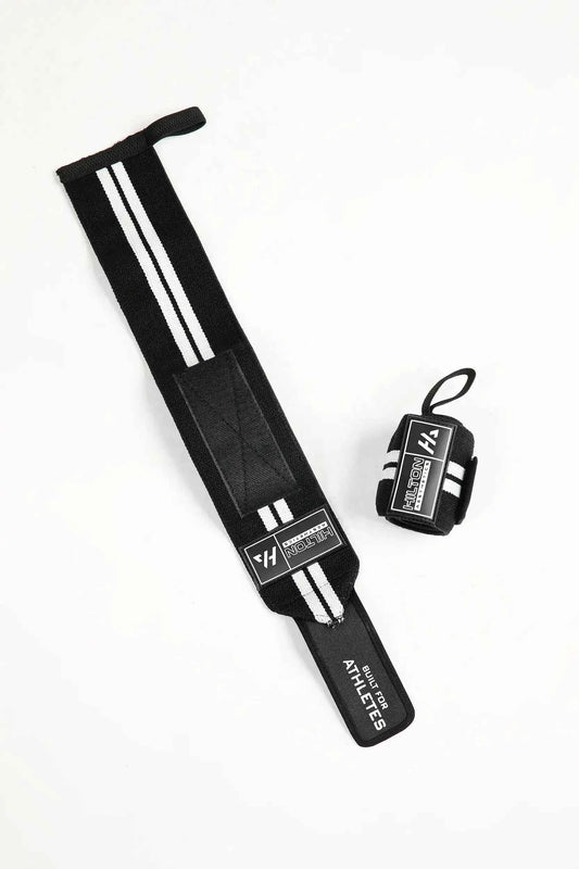 Black Hilton Aesthetics weightlifting wrist wraps with thumb loops, flat-lay view